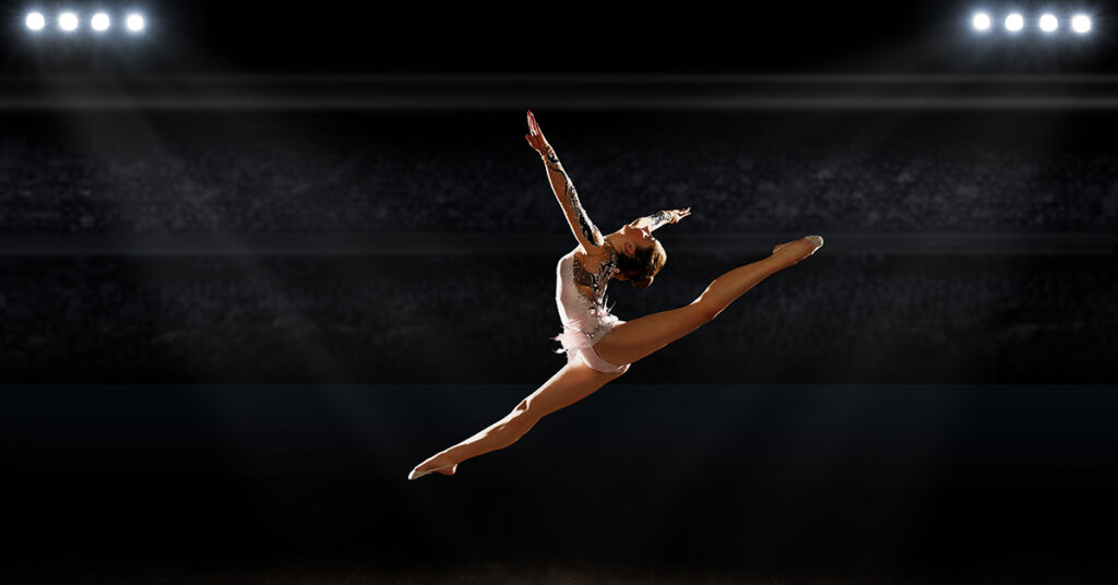Girl engaged art gymnastics at sports hall