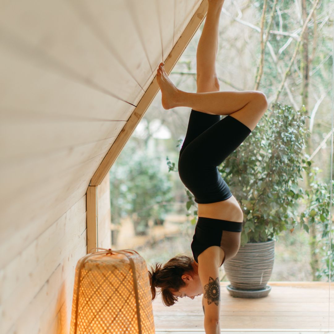 Gymnast practicing hand stand at home