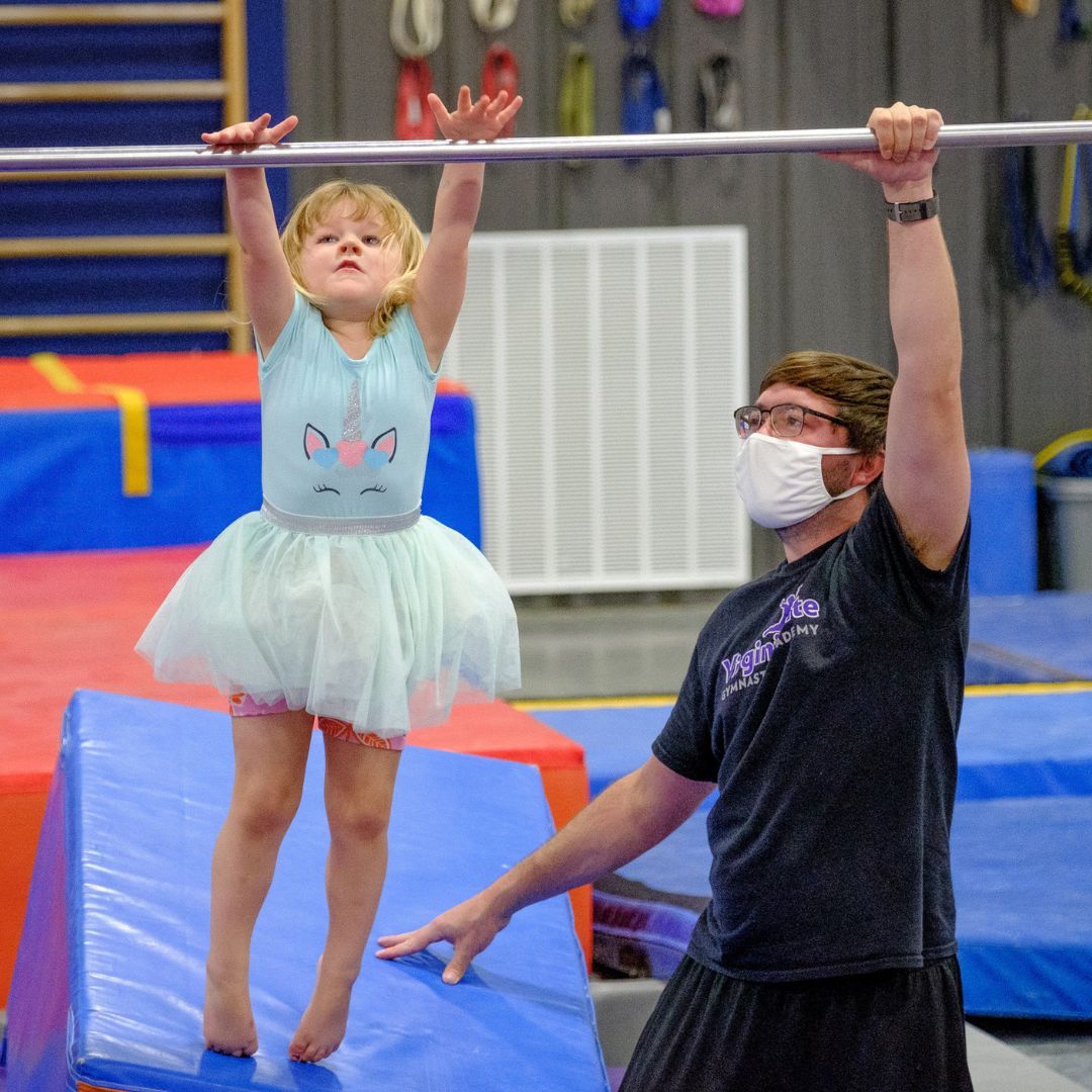 gymnast hanging from bars