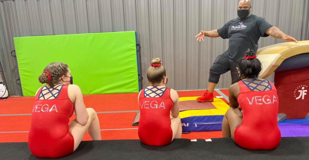 gymnasts listening to coach talk
