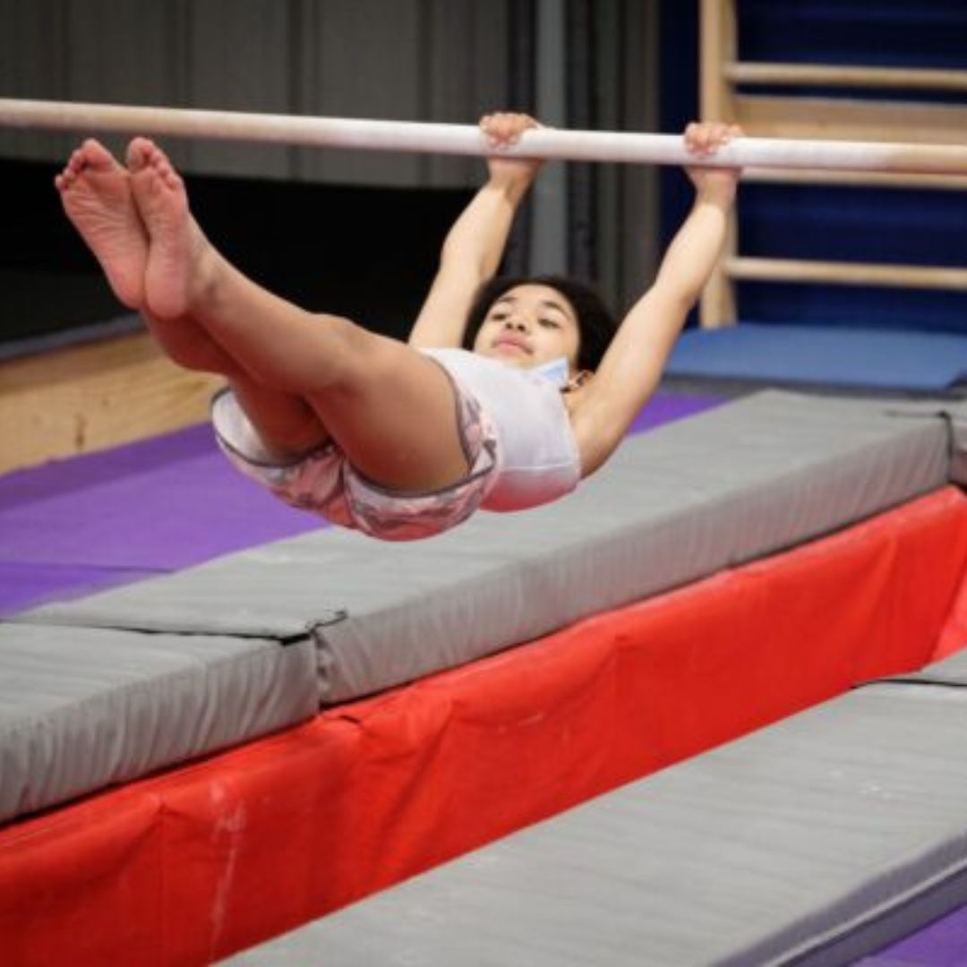 gymnast swinging on pole