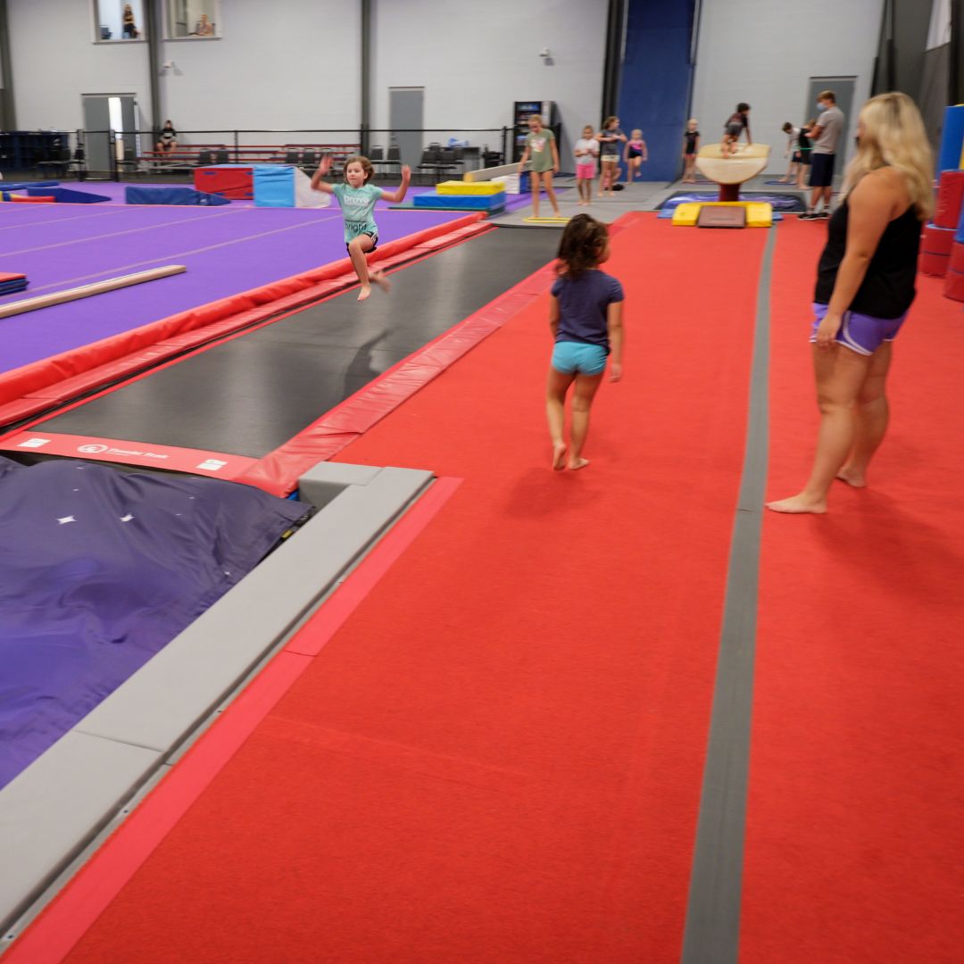 coach supervising gymnast
